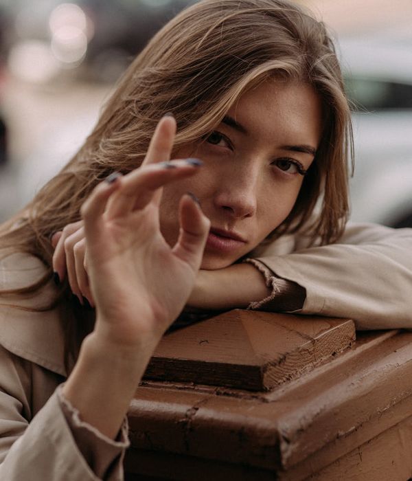 Person stretching peacefully outdoors with a serene natural landscape in the background.